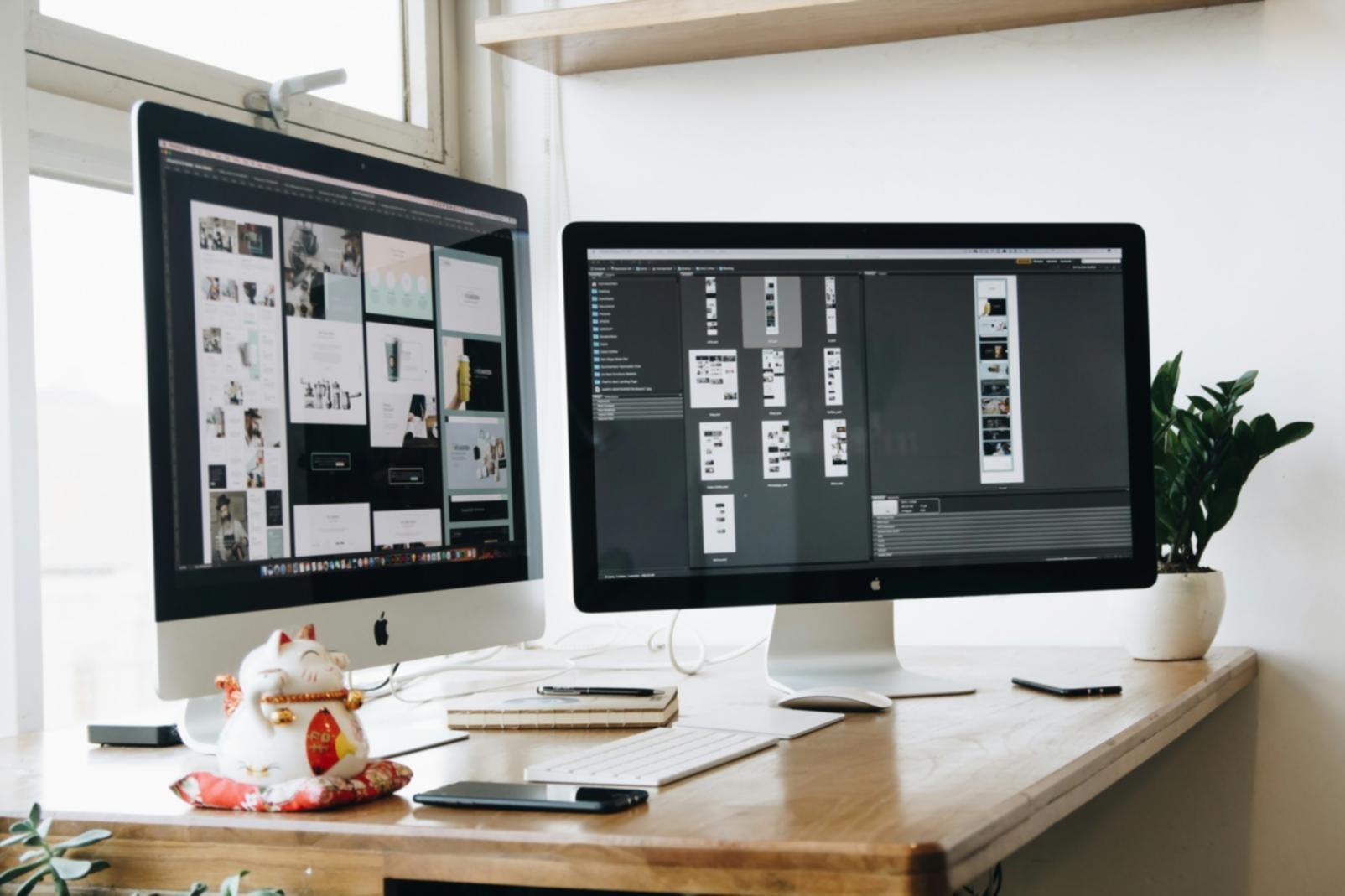 Code optimization workspace with multiple monitors showing performance metrics
